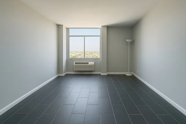 a view of an empty room with a window