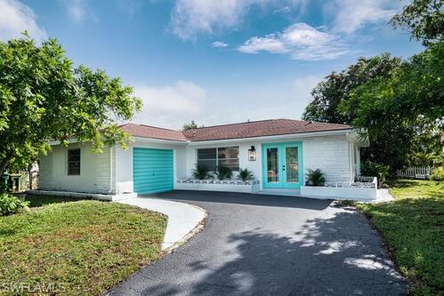4666 Dorando Drive Naples, FL 34103 - Photo 2 of 30 a front view of a house with a yard and potted plants