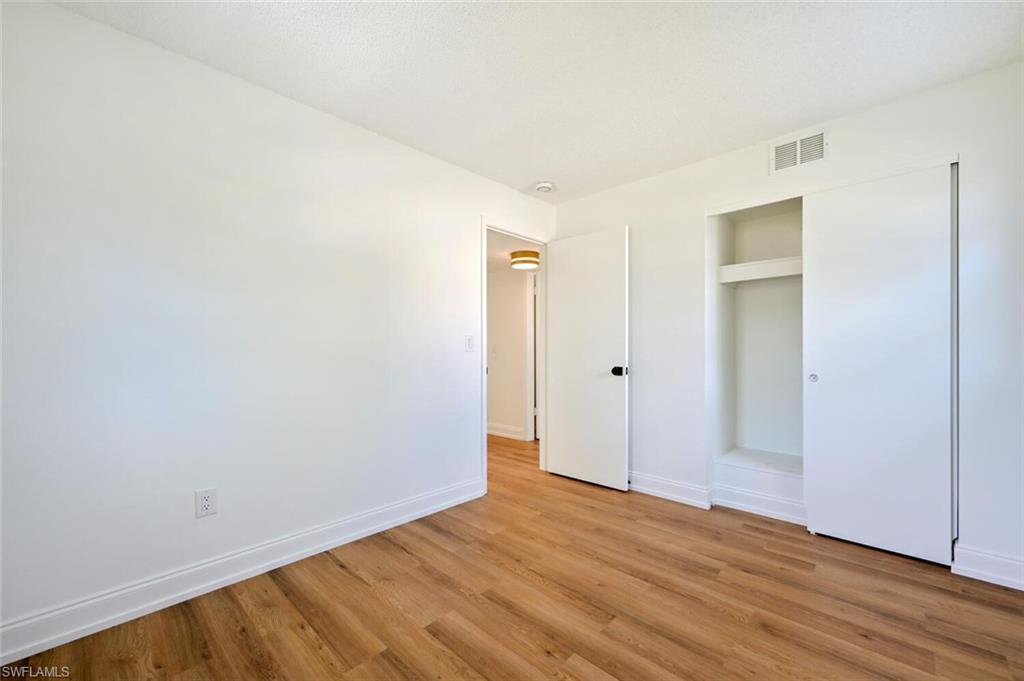 4666 Dorando Drive Naples, FL 34103 - Photo 24 of 30 an empty room with wooden floor and closet