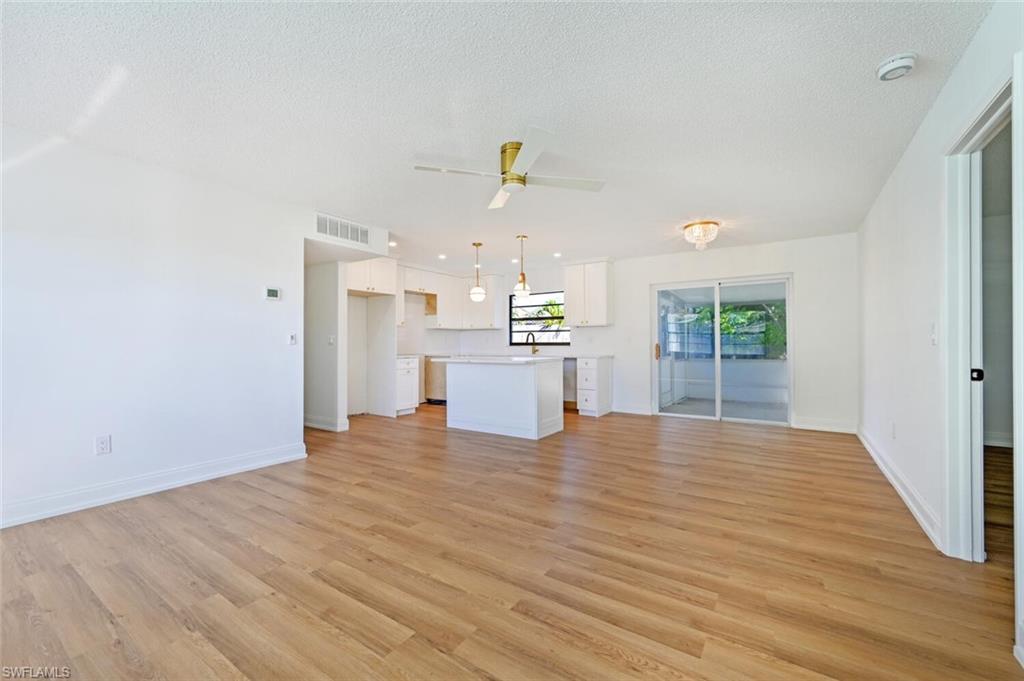 4666 Dorando Drive Naples, FL 34103 - Photo 5 of 30 a view of a kitchen with wooden floor and windows