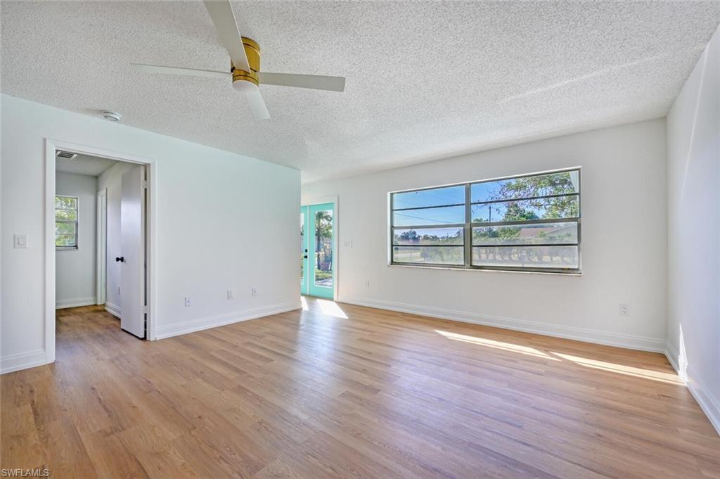 4666 Dorando Drive Naples, FL 34103 - Photo 6 of 30 an empty room with wooden floor and windows