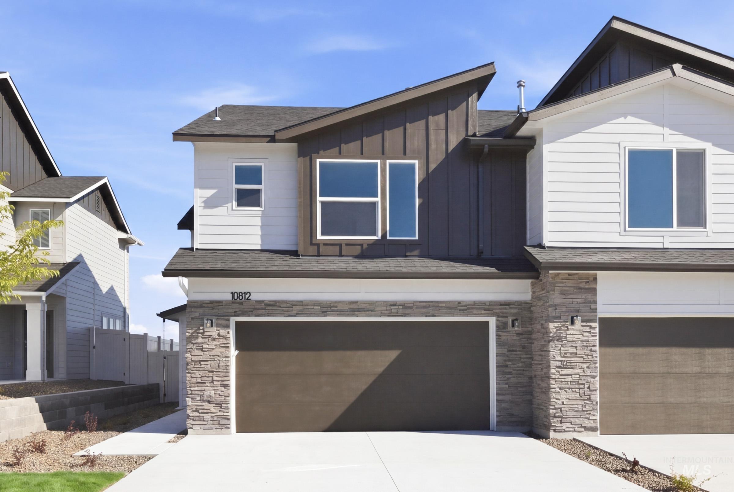 10812 Rutland Street Caldwell, ID 83605 - Photo 1 of 21 Modern facade with stacked stone accents and vertical siding