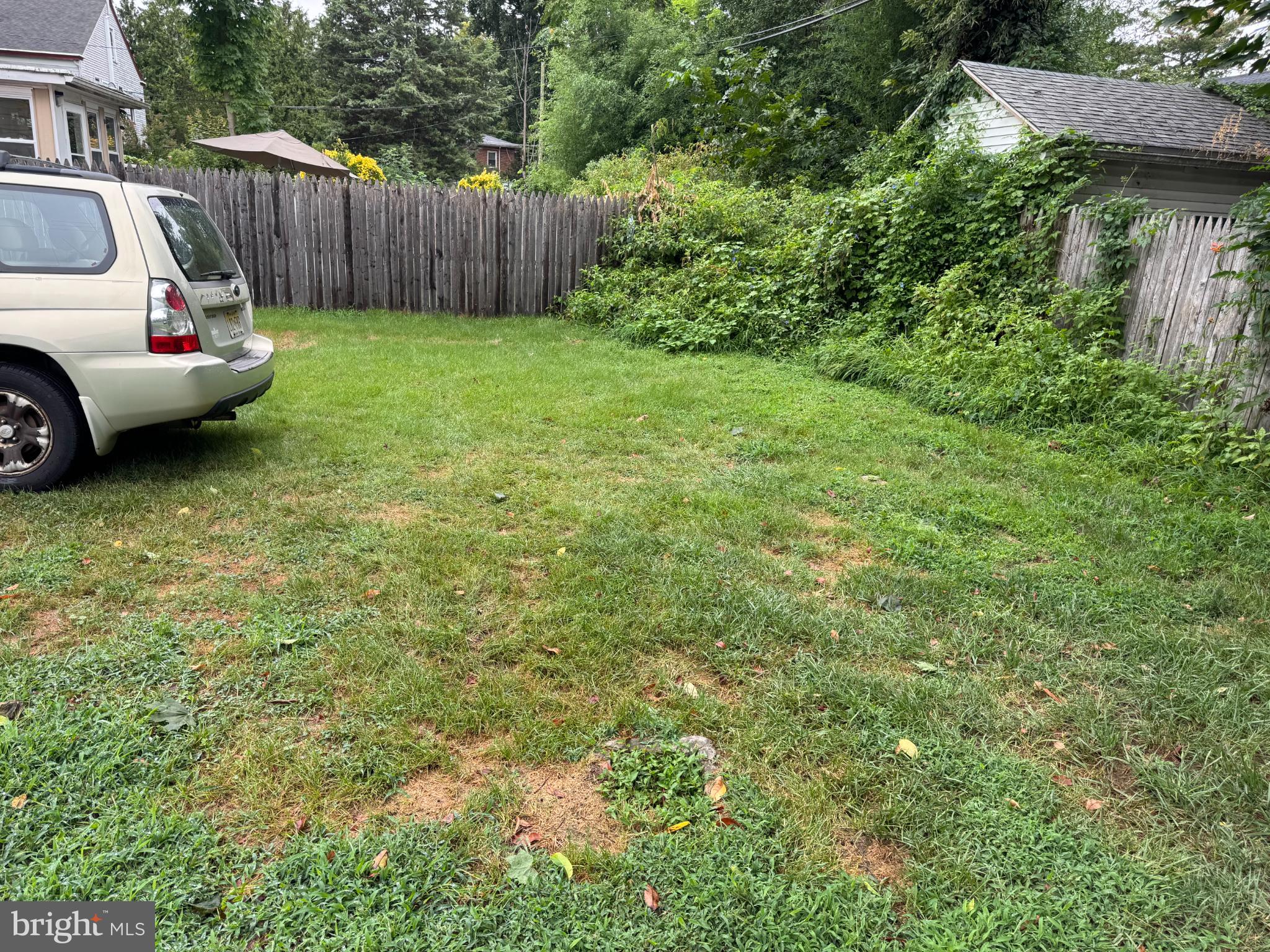 331 West Front Street, Unit 2 Florence, NJ 08518 - Photo 6 of 13 a view of a backyard with table and chairs and wooden fence