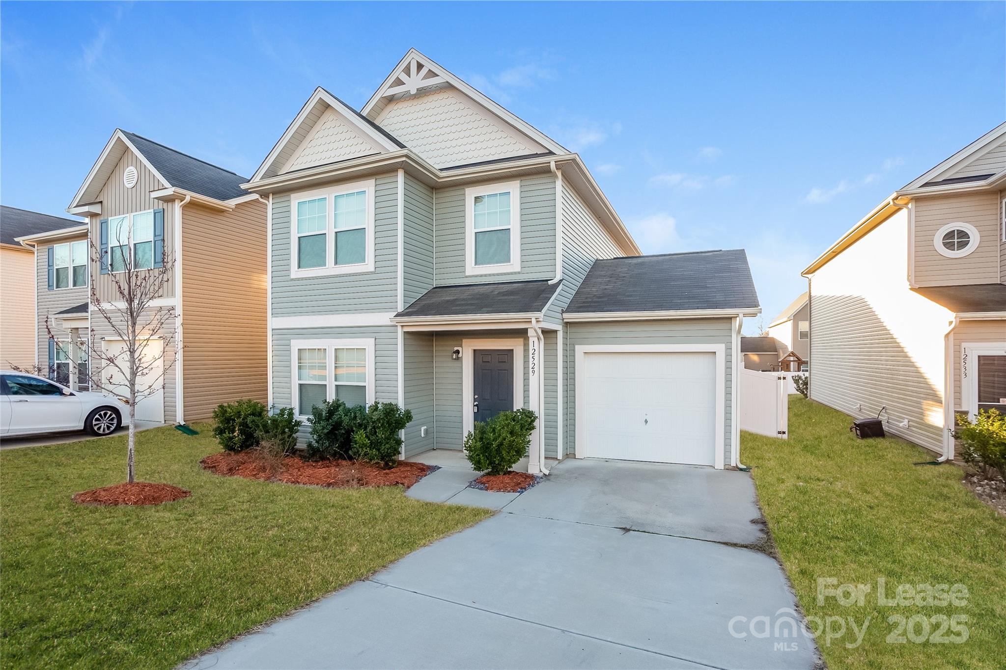 12529 Garron Road Midland, NC 28107 - Photo 3 of 15 a view of a white house next to a yard with big trees