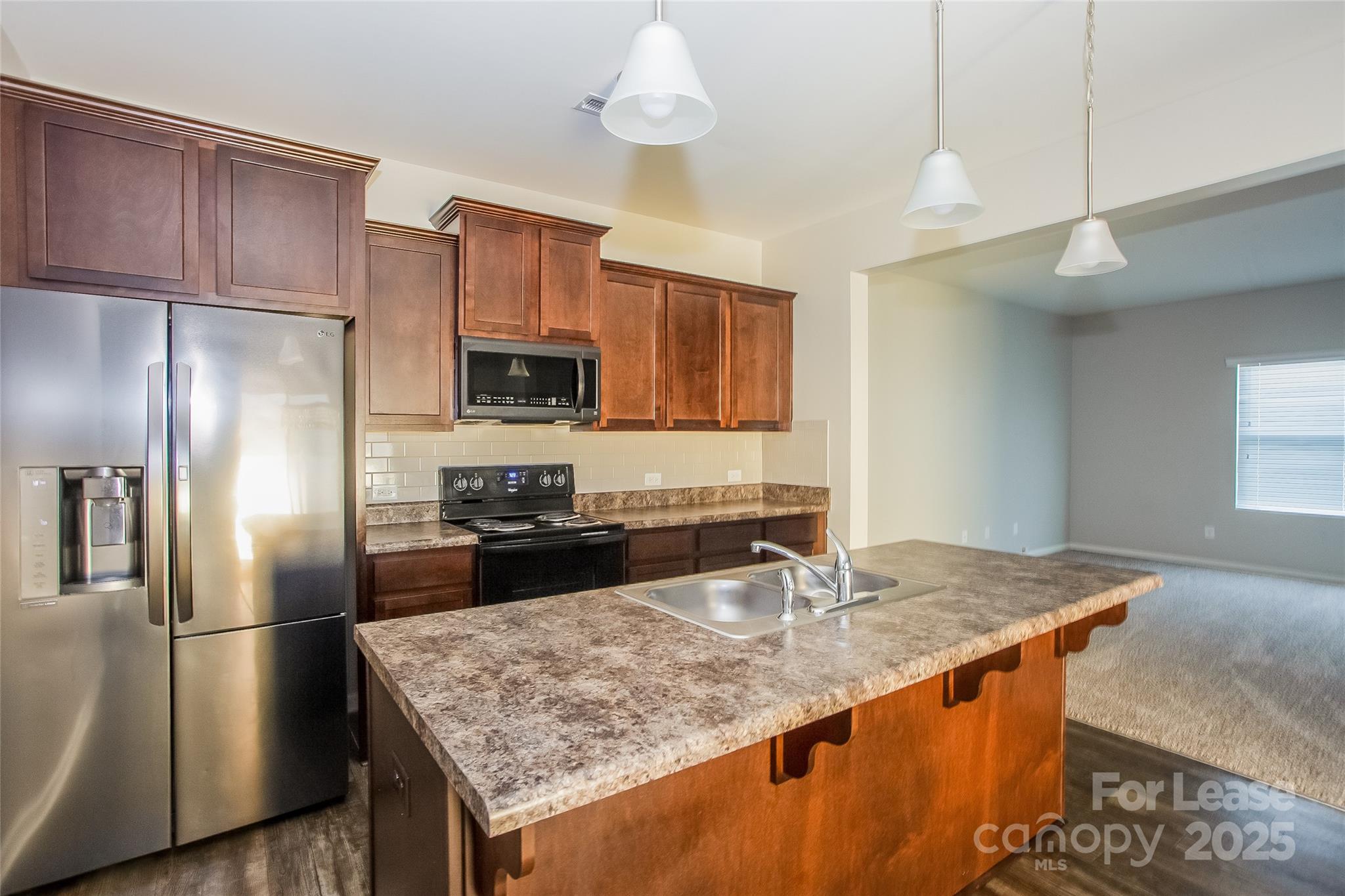 12529 Garron Road Midland, NC 28107 - Photo 5 of 15 a kitchen with stainless steel appliances granite countertop a sink a refrigerator and a counter space