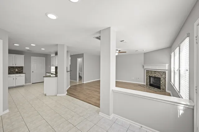 a view of a kitchen with a sink dishwasher and a fireplace