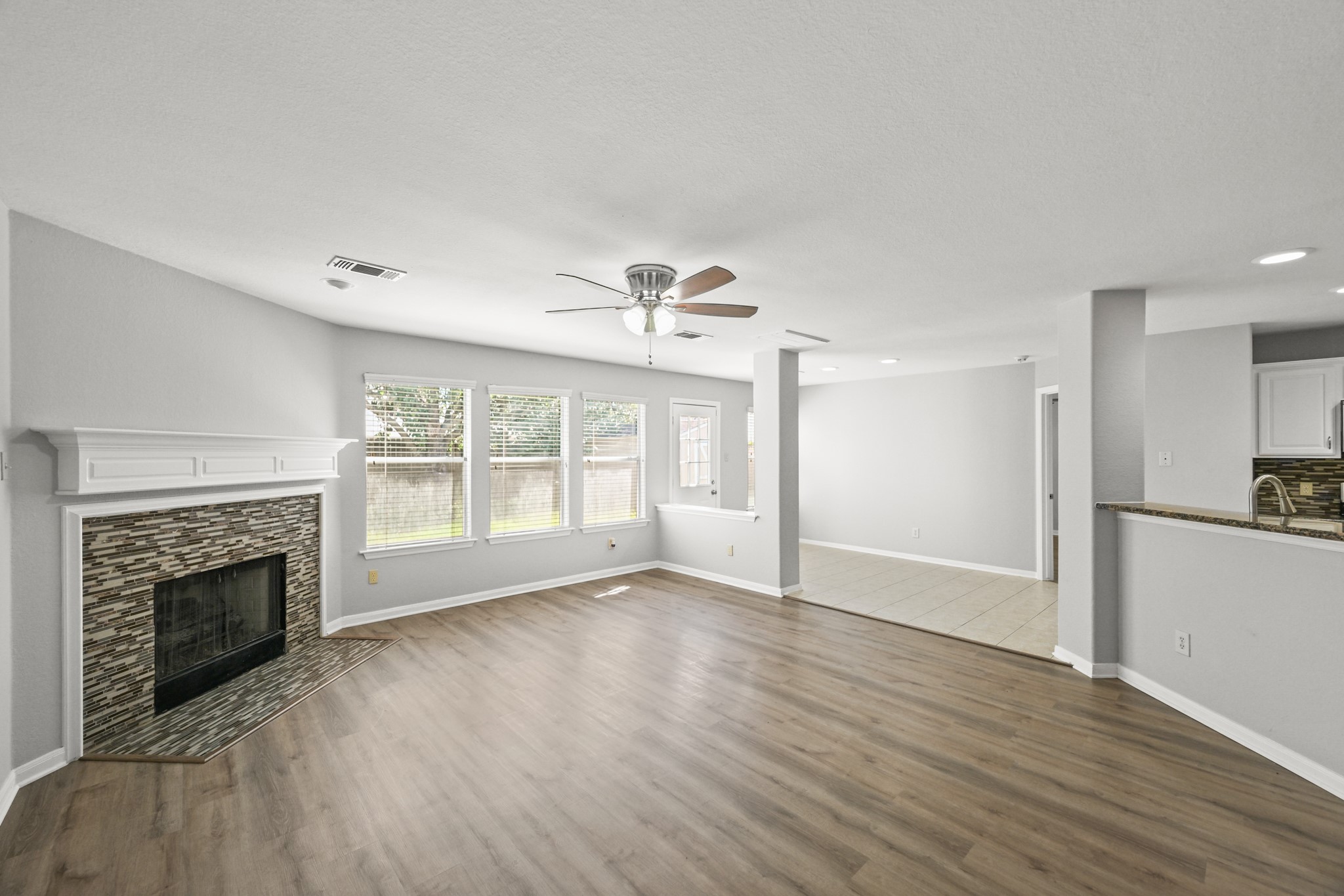 14614 Hazy Ridge Lane Cypress, TX 77429 - Photo 14 of 36 a view of an empty room with wooden floor fireplace and a window