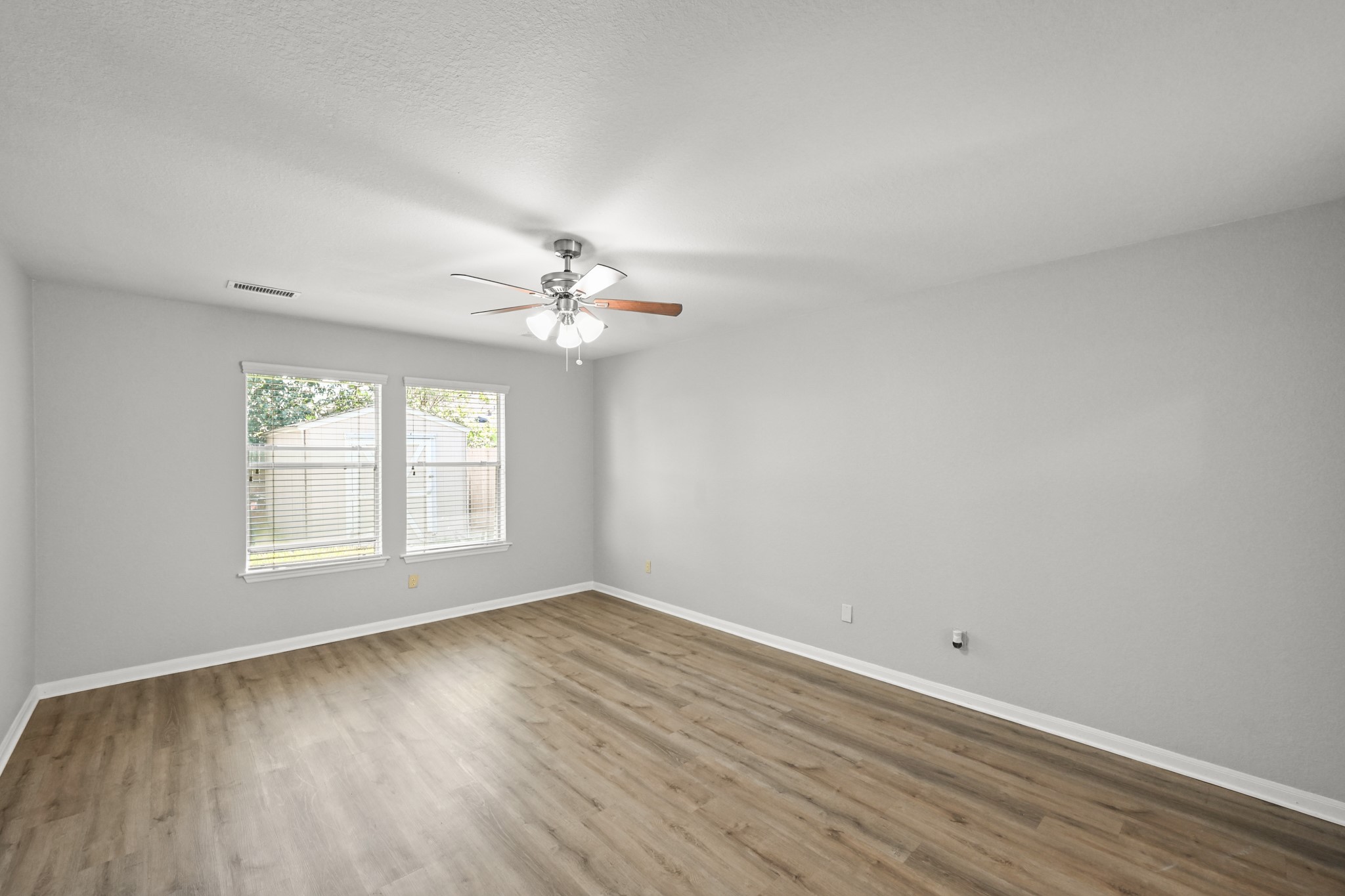 14614 Hazy Ridge Lane Cypress, TX 77429 - Photo 17 of 36 a view of an empty room with wooden floor and a window