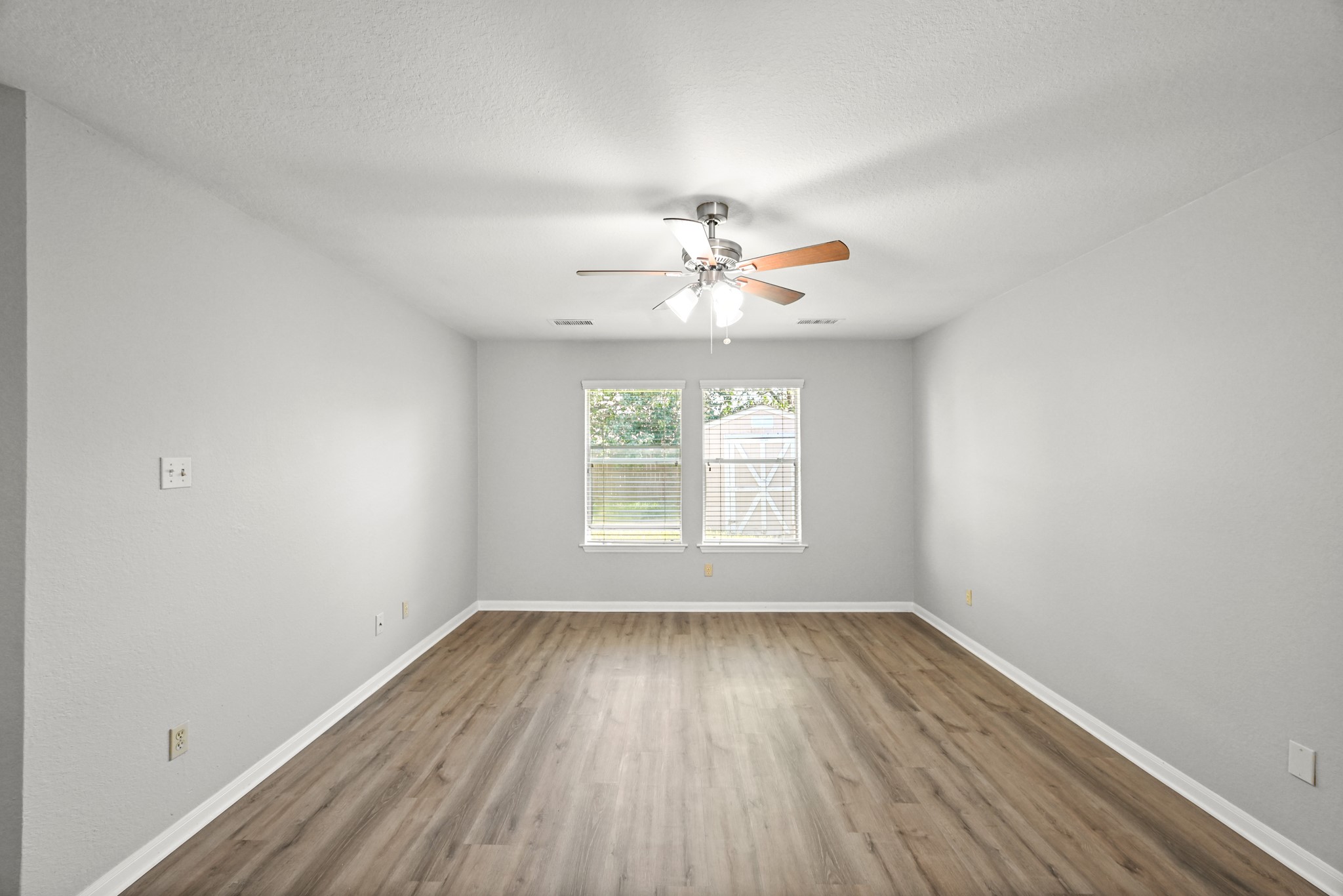 14614 Hazy Ridge Lane Cypress, TX 77429 - Photo 19 of 36 an empty room with a window and wooden floor
