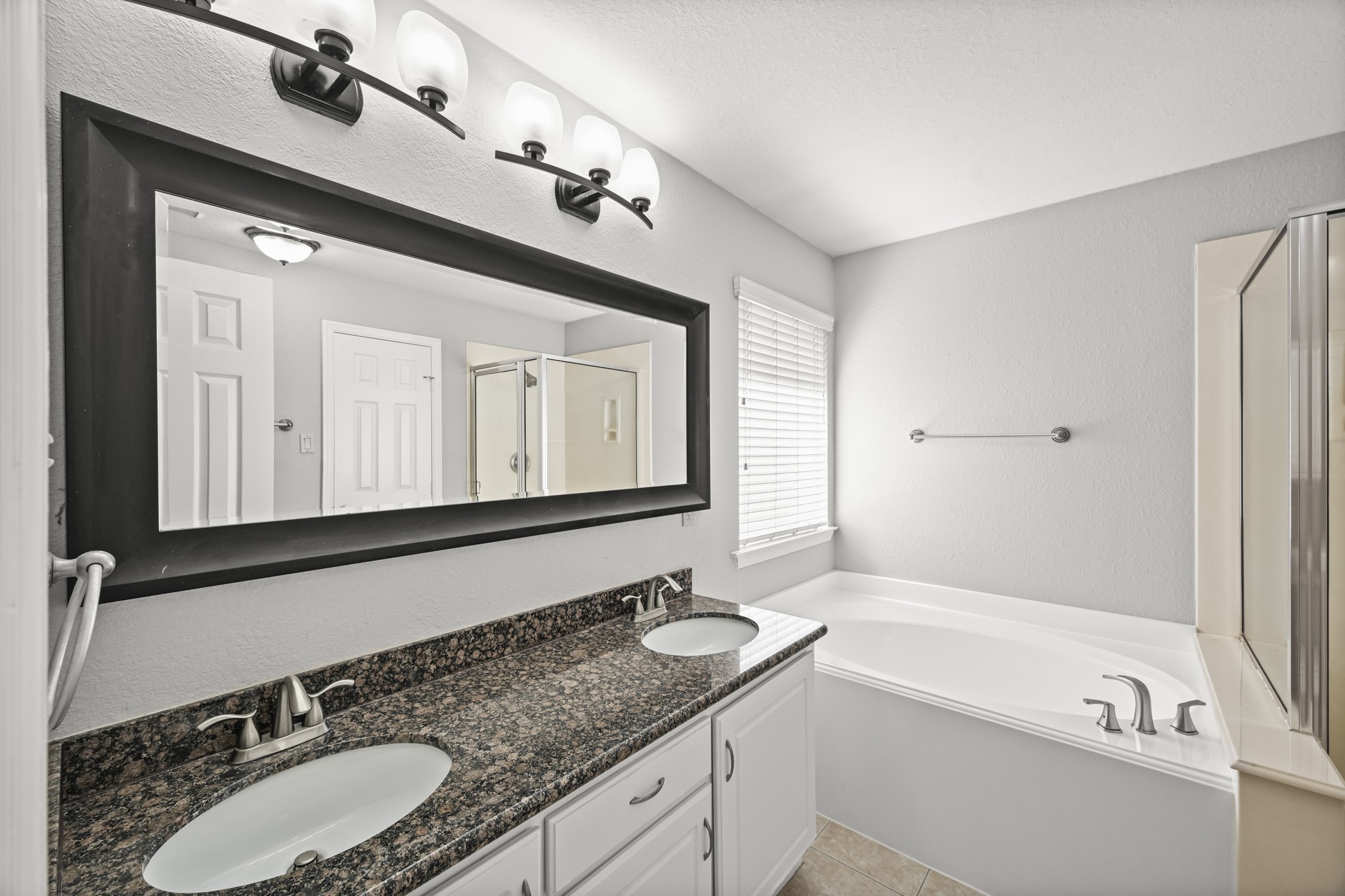 14614 Hazy Ridge Lane Cypress, TX 77429 - Photo 20 of 36 a bathroom with a granite countertop sink mirror and bathtub