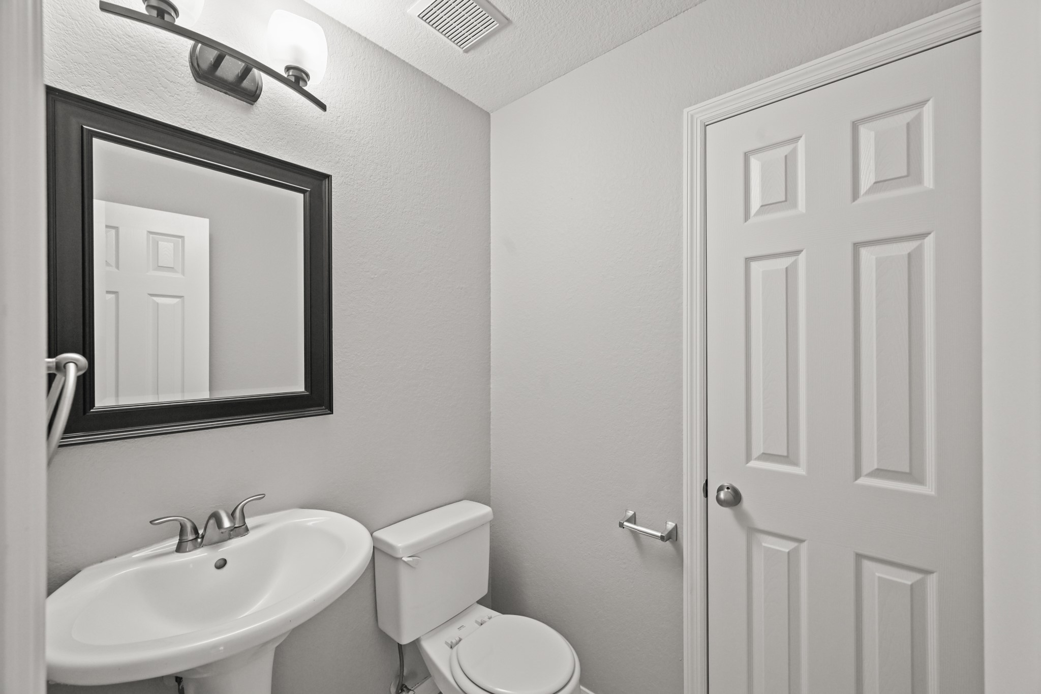 14614 Hazy Ridge Lane Cypress, TX 77429 - Photo 21 of 36 a bathroom with a toilet sink and mirror
