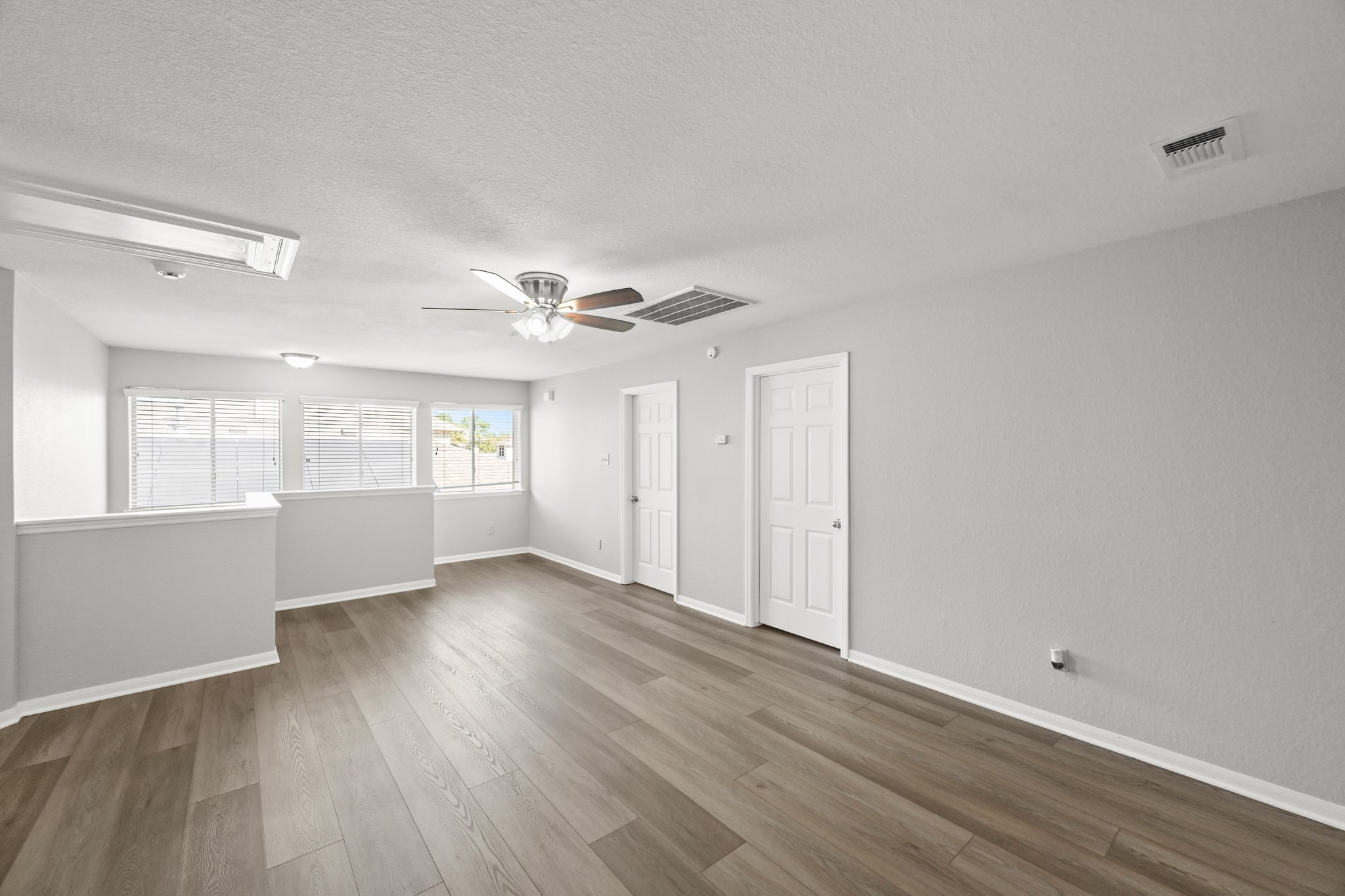 14614 Hazy Ridge Lane Cypress, TX 77429 - Photo 28 of 36 a view of an empty room with a window and wooden floor