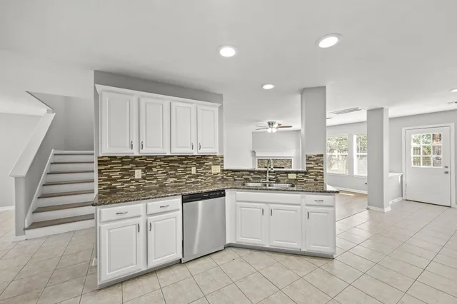 a kitchen with stainless steel appliances granite countertop a sink and cabinets