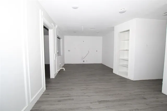 a view of a room with wooden floor