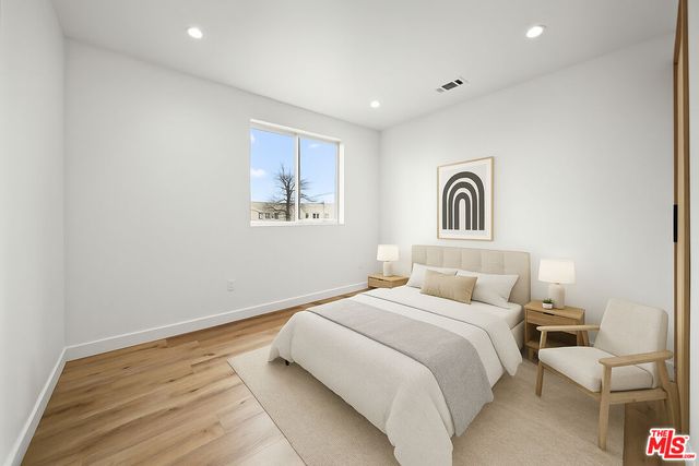 a bedroom with a bed and a couch