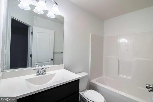 a bathroom with a sink a toilet and bathtub