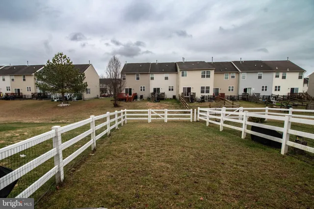 a view of a big building with big yard and large trees