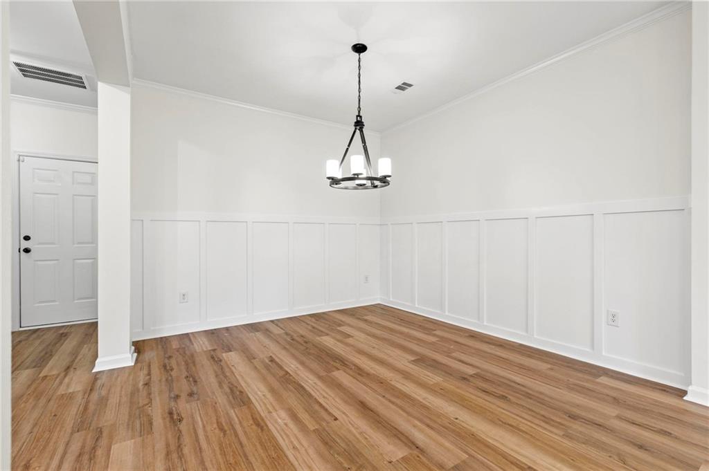 2615 Maple Leaf Terrace Cumming, GA 30041 - Photo 11 of 34 a view of a room with wooden floor closet and a ceiling fan