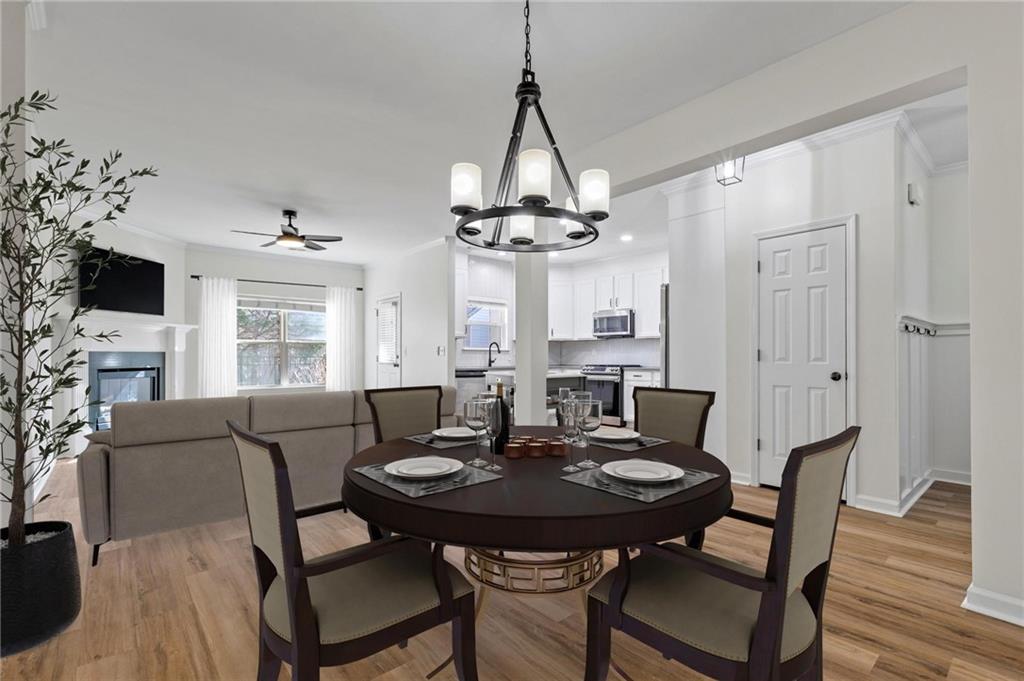 2615 Maple Leaf Terrace Cumming, GA 30041 - Photo 12 of 34 a view of a dining room with furniture and wooden floor