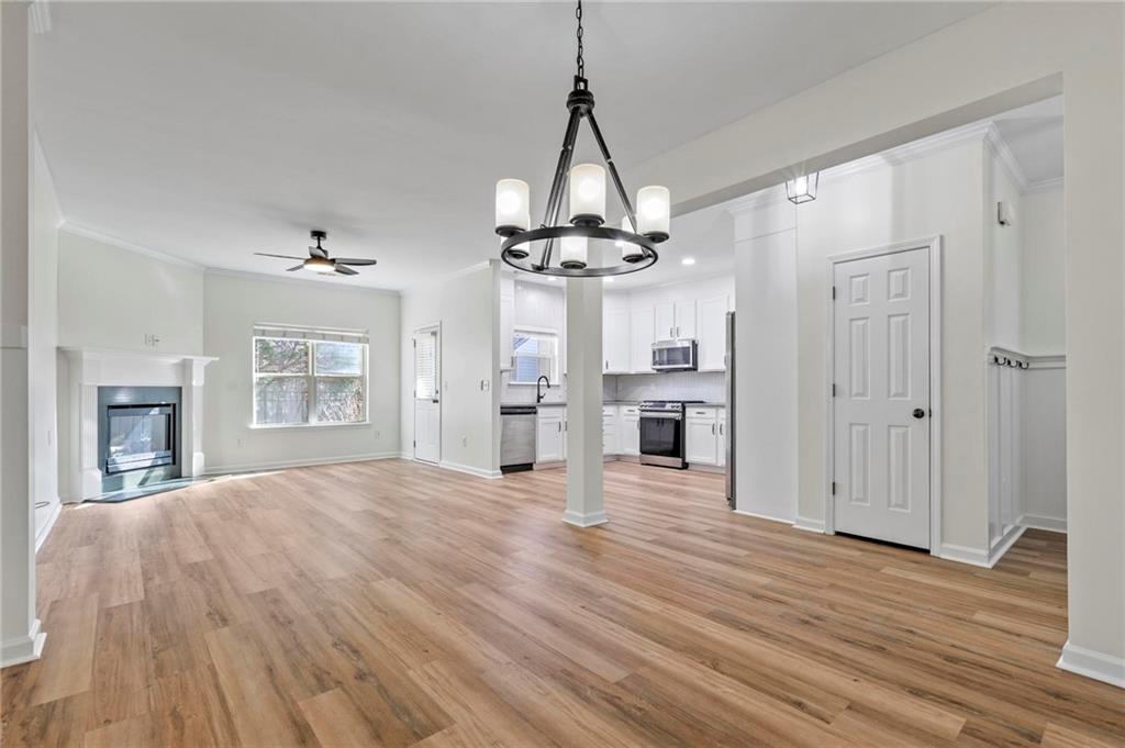 2615 Maple Leaf Terrace Cumming, GA 30041 - Photo 13 of 34 a view of a room with wooden floor fireplace and windows