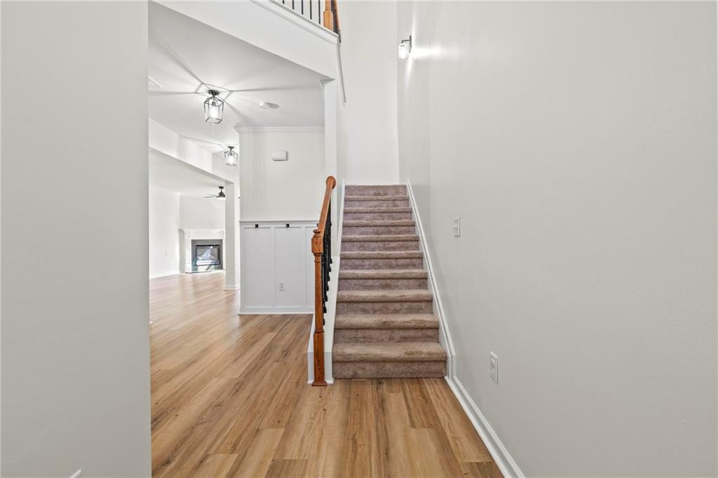 2615 Maple Leaf Terrace Cumming, GA 30041 - Photo 14 of 34 a view of a hallway with wooden floor and staircase