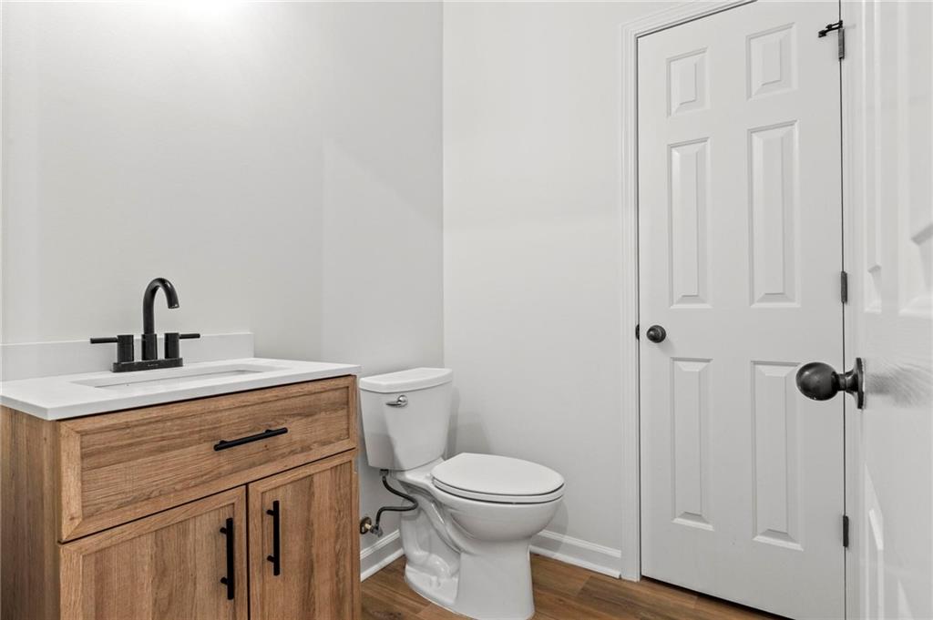 2615 Maple Leaf Terrace Cumming, GA 30041 - Photo 15 of 34 a bathroom with a toilet a sink and vanity