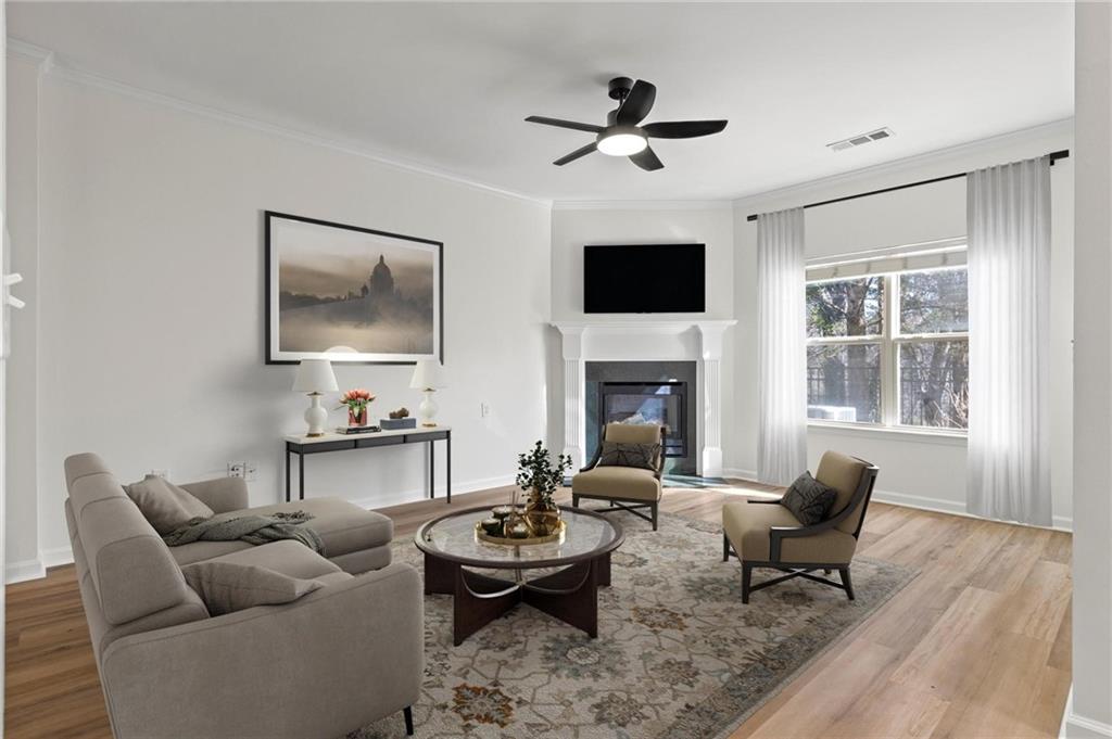 2615 Maple Leaf Terrace Cumming, GA 30041 - Photo 2 of 34 a living room with furniture a rug and a flat screen tv