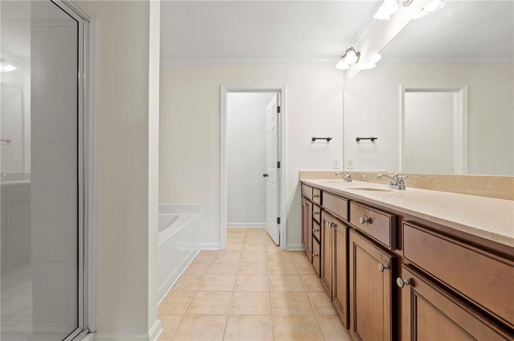 2615 Maple Leaf Terrace Cumming, GA 30041 - Photo 22 of 34 a bathroom with a sink a vanity and a mirror