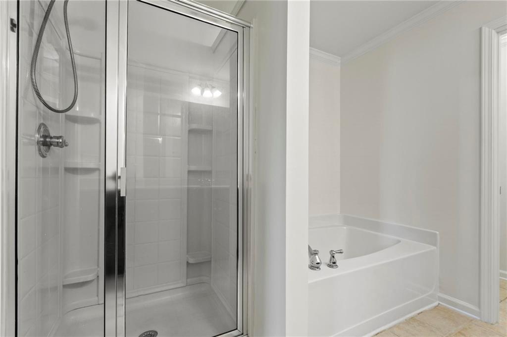 2615 Maple Leaf Terrace Cumming, GA 30041 - Photo 23 of 34 a white bath tub sitting next to a shower