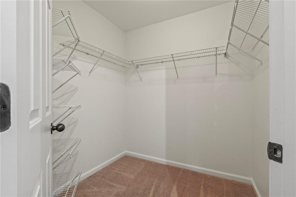 2615 Maple Leaf Terrace Cumming, GA 30041 - Photo 24 of 34 a view of a room with racks on the wall