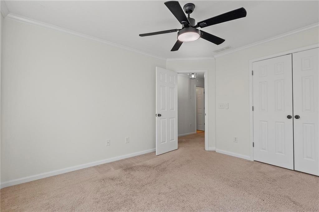 2615 Maple Leaf Terrace Cumming, GA 30041 - Photo 26 of 34 an empty room with a ceiling fan and a window