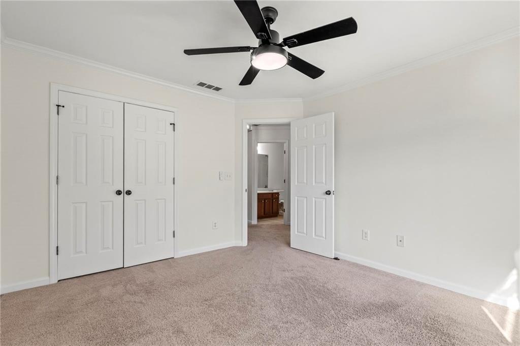 2615 Maple Leaf Terrace Cumming, GA 30041 - Photo 29 of 34 an empty room with closet and a ceiling fan