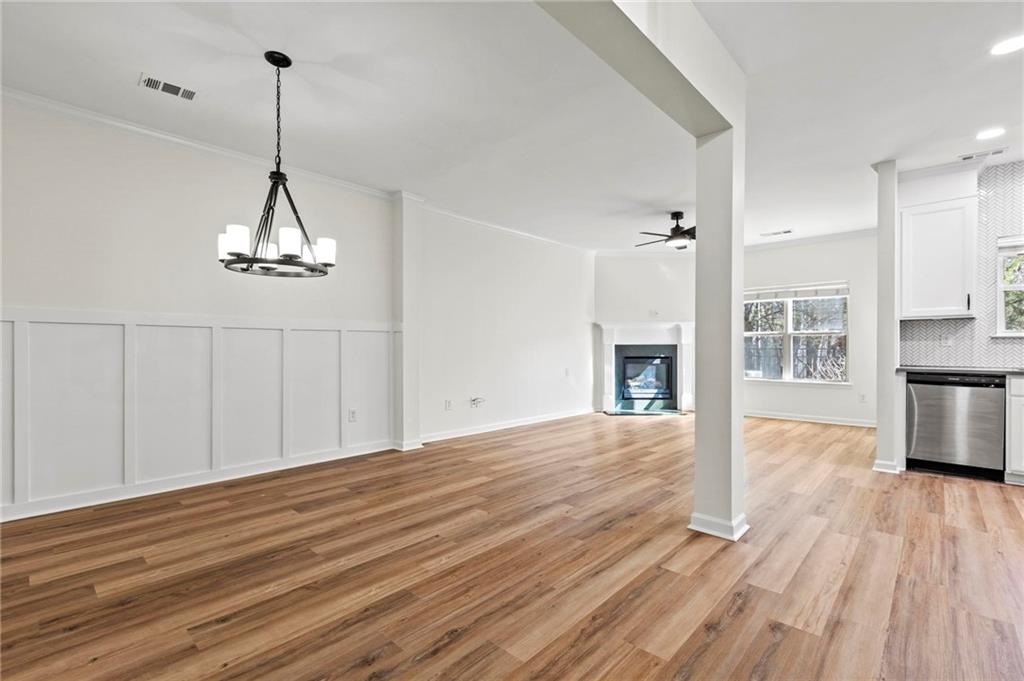 2615 Maple Leaf Terrace Cumming, GA 30041 - Photo 4 of 34 a view of a room with wooden floor and a ceiling fan