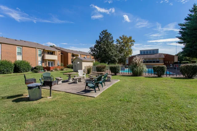 a view of a house with backyard sitting area and garden