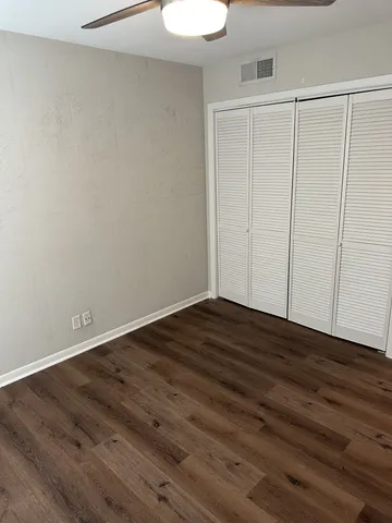 a view of a room with wooden floor