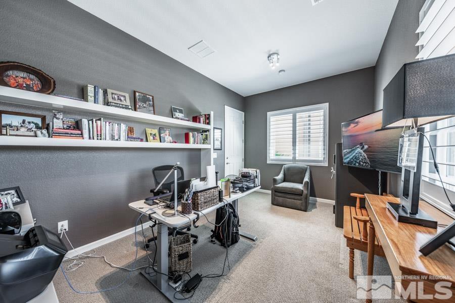 9826 Dyevera Lane Reno, NV 89521 - Photo 23 of 39 a living room with furniture a flat screen tv and a fireplace