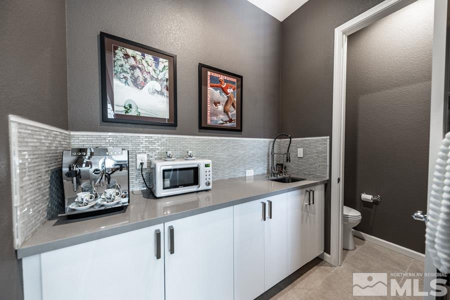 9826 Dyevera Lane Reno, NV 89521 - Photo 24 of 39 a kitchen with stainless steel appliances granite countertop a sink and a microwave