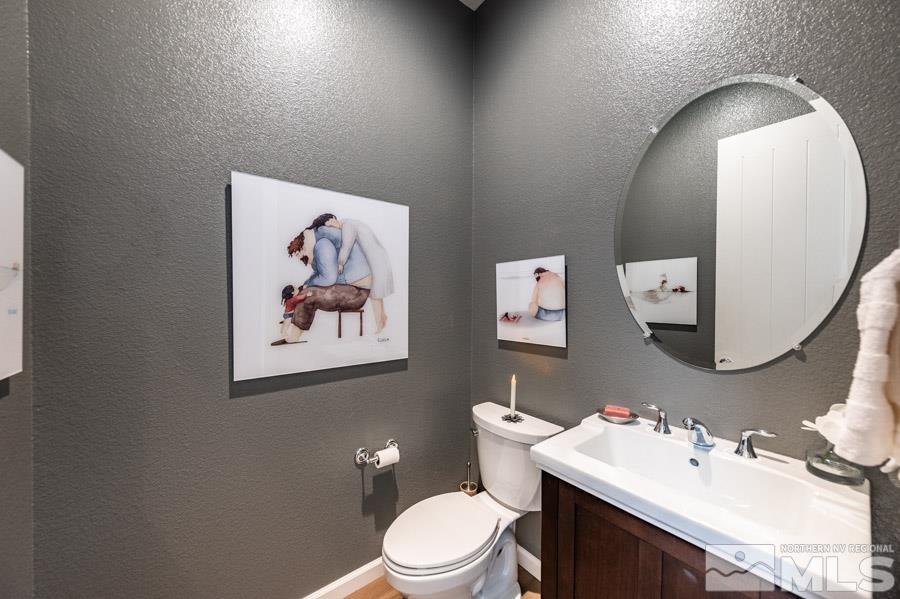 9826 Dyevera Lane Reno, NV 89521 - Photo 25 of 39 a bathroom with a toilet a sink and mirror