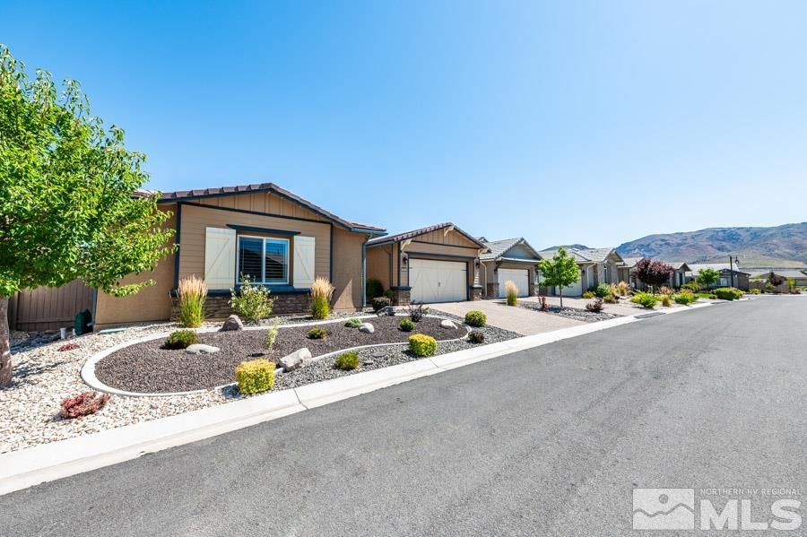9826 Dyevera Lane Reno, NV 89521 - Photo 3 of 39 a front view of house with yard outdoor seating and barbeque oven