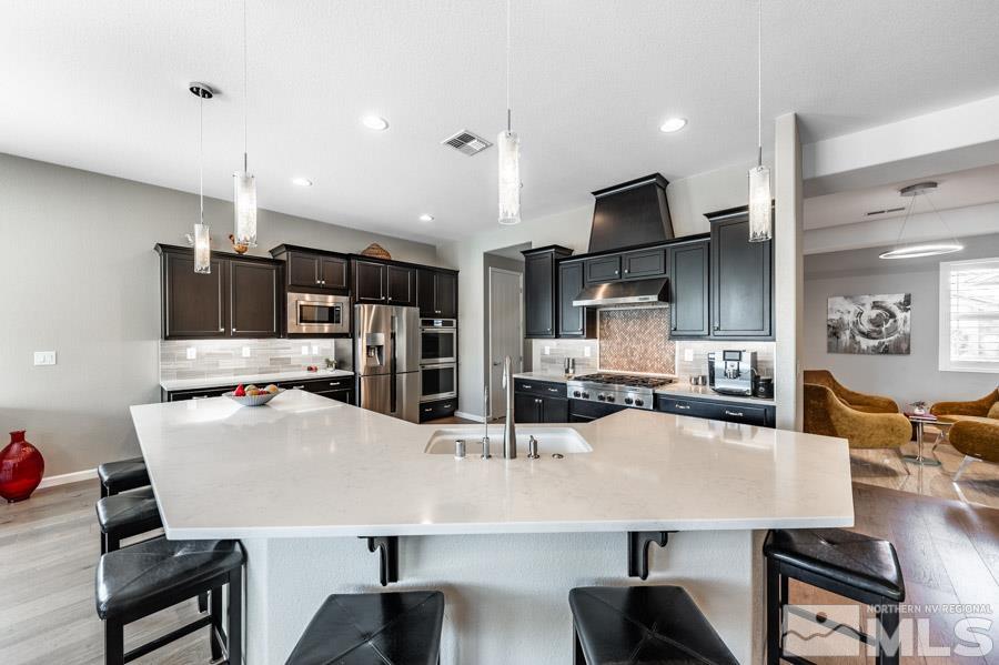 9826 Dyevera Lane Reno, NV 89521 - Photo 7 of 39 a large kitchen with a table and chairs