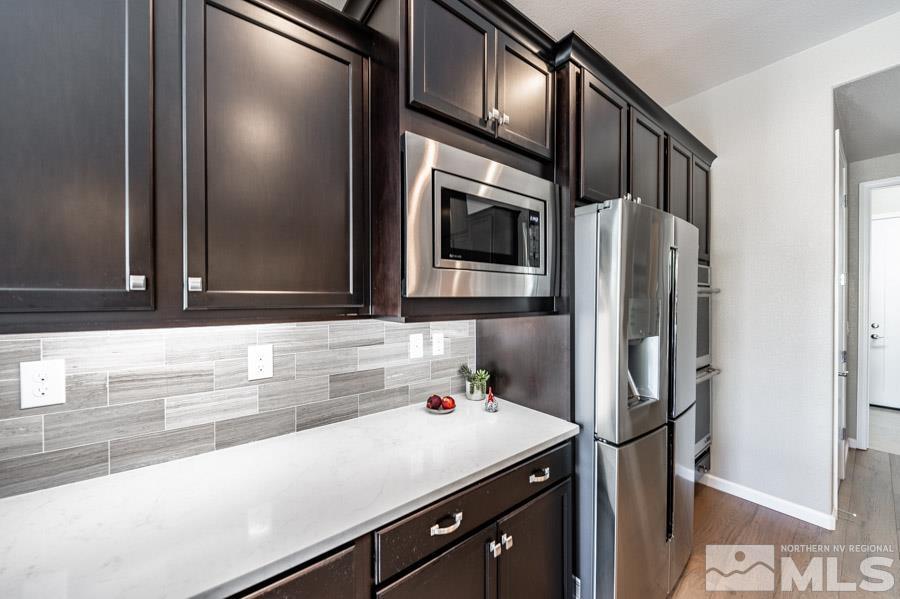 9826 Dyevera Lane Reno, NV 89521 - Photo 8 of 39 a kitchen with a refrigerator and a sink