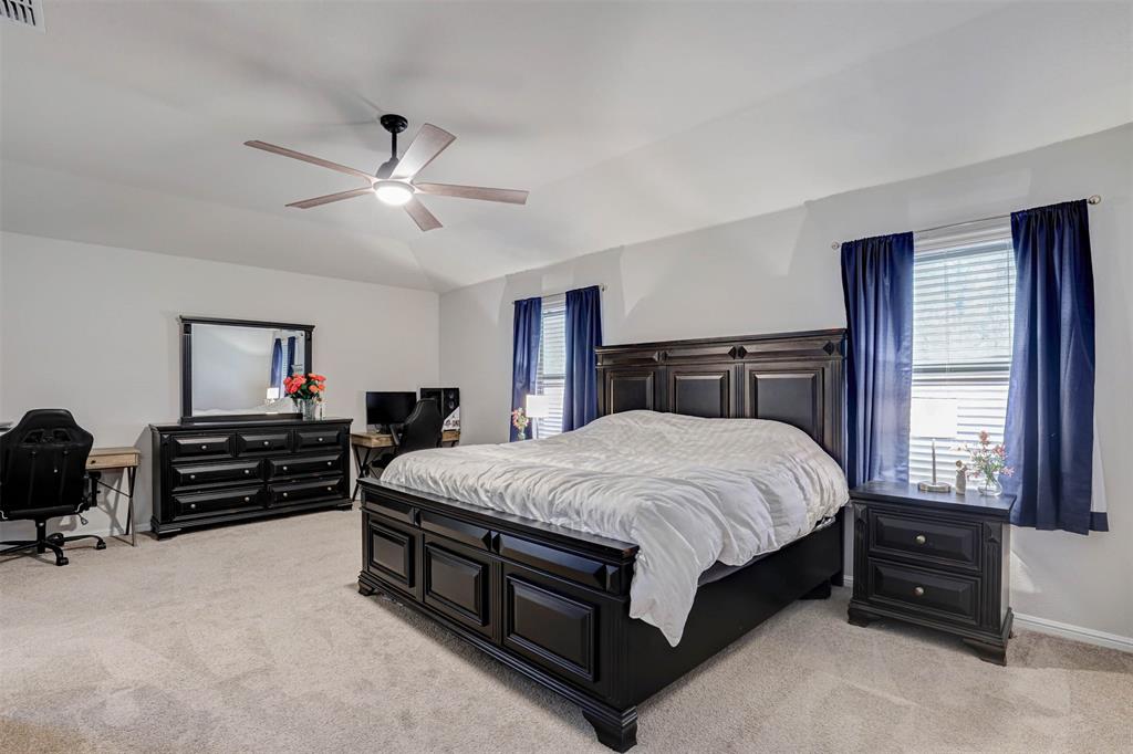 512 Amory Street Azle, TX 76020 - Photo 11 of 25 a bedroom with a bed and a tv