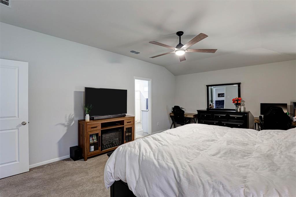 512 Amory Street Azle, TX 76020 - Photo 13 of 25 a bed room with a bed and a flat screen tv