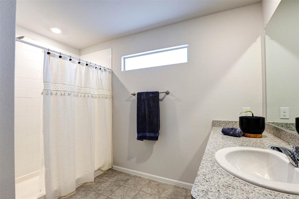 512 Amory Street Azle, TX 76020 - Photo 14 of 25 a bathroom with a sink and a tub