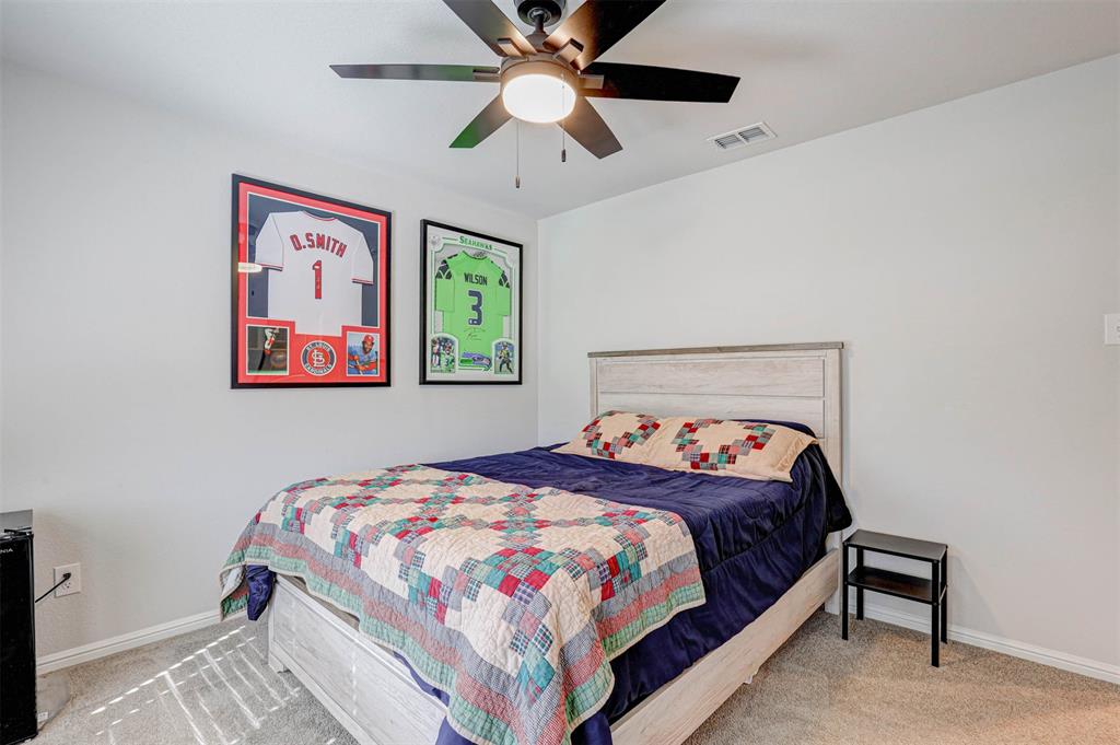 512 Amory Street Azle, TX 76020 - Photo 17 of 25 a bedroom with a bed and a chandelier