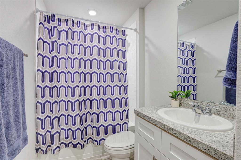 512 Amory Street Azle, TX 76020 - Photo 18 of 25 a bathroom with a sink and toilet