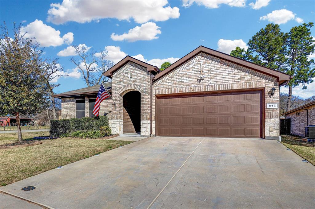 512 Amory Street Azle, TX 76020 - Photo 2 of 25 a front view of a house with a yard and garage