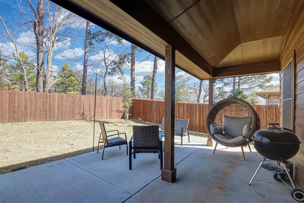 512 Amory Street Azle, TX 76020 - Photo 23 of 25 a view of a porch with furniture and a backyard