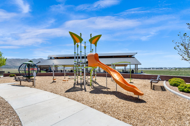 6120 North Sheps Ridge Road Eagle Mountain, UT 84005 - Photo 34 of 43 Community playground featuring a slide, climbing structures, wood chip surfacing, and a covered picnic area