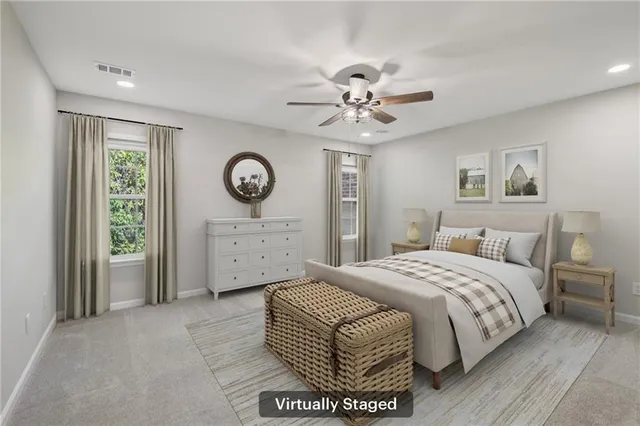 a spacious bedroom with a bed a window and closet